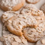 Almond Snowflake Cookies with white icing and glitter