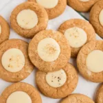 Classic Snickerdoodle Christmas Cookies on plate with milk and Christmas lights