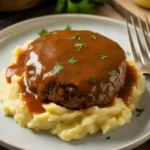 Slow cooker Salisbury steak with garlic herb gravy over mashed potatoes