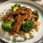 Slow Cooker Beef and Broccoli served warm in a rustic bowl