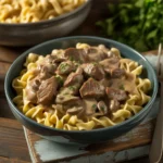 Bowl of Crockpot Beef Stroganoff with creamy sauce and parsley