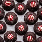 Chocolate peppermint thumbprint cookies with candy cane topping