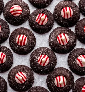 Chocolate peppermint thumbprint cookies with candy cane topping