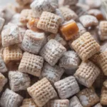 Delicious caramel apple puppy chow snack mix with apples and caramel drizzle.