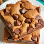 Delicious Chocolate Chip Pecan Pie Bars topped with pecans and chocolate chips