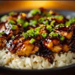 Delicious Honey BBQ Chicken Rice served in a bowl, topped with green onions.