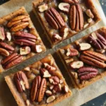 No-bake pecan pie bars topped with honey for a delicious dessert