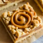 Delicious salted caramel pecan pie bars stacked on a plate
