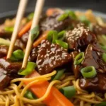 Slow cooker beef ramen noodles in a bowl with garnishes