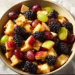Fresh fall fruit salad with cinnamon orange dressing in a bowl