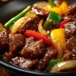 Sizzling Chinese pepper steak with onions served on a plate