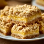 Lemon Oatmeal Crumble Bars on a plate garnished with lemon slices