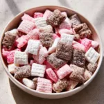 Delicious Neapolitan Puppy Chow with chocolate, peanut butter, and strawberry flavors