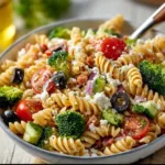 Simple high protein pasta salad with colorful vegetables and dressing