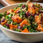 Delicious sweet potato kale salad topped with nuts and dressing
