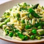Cold asparagus orzo salad with fresh vegetables and dressing