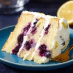 Lemon Blueberry Cake with fresh blueberries and lemon zest on a plate