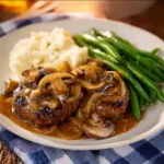 Deliciously prepared Salisbury Steak with gravy and sides on a plate