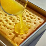 Triple Lemon Poke Cake with lemon glaze and whipped cream topping