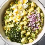 Delicious avocado egg salad served in a bowl with fresh herbs